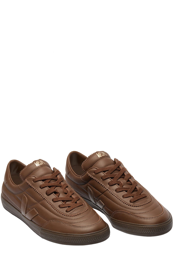 Top view of Veja sneakers in dark brown with seamlines made from leather shown against a plain white background.