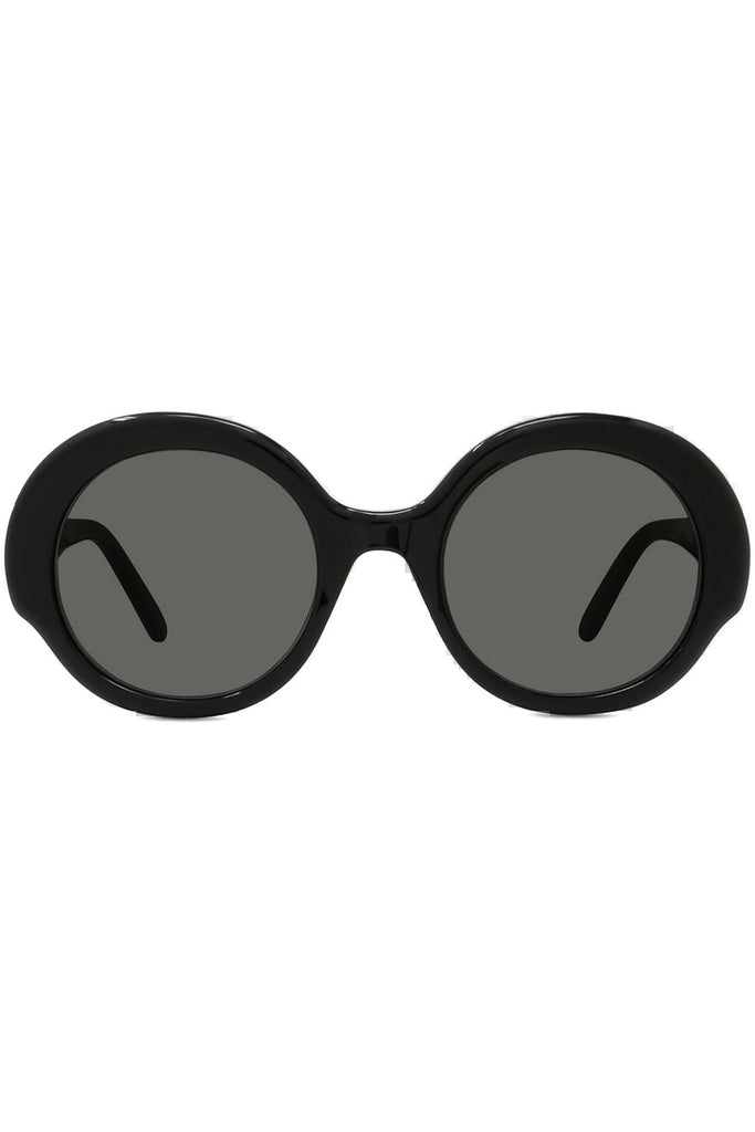 Oversized round sunglasses with a thick black frame and dark gray lenses, shown from the front on a plain white background.