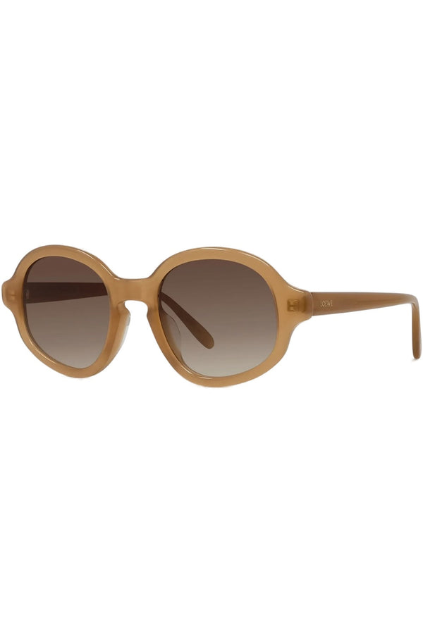 Oval sunglasses with a warm tan acetate frame and brown gradient lenses, shown from a side angle on a plain white background.