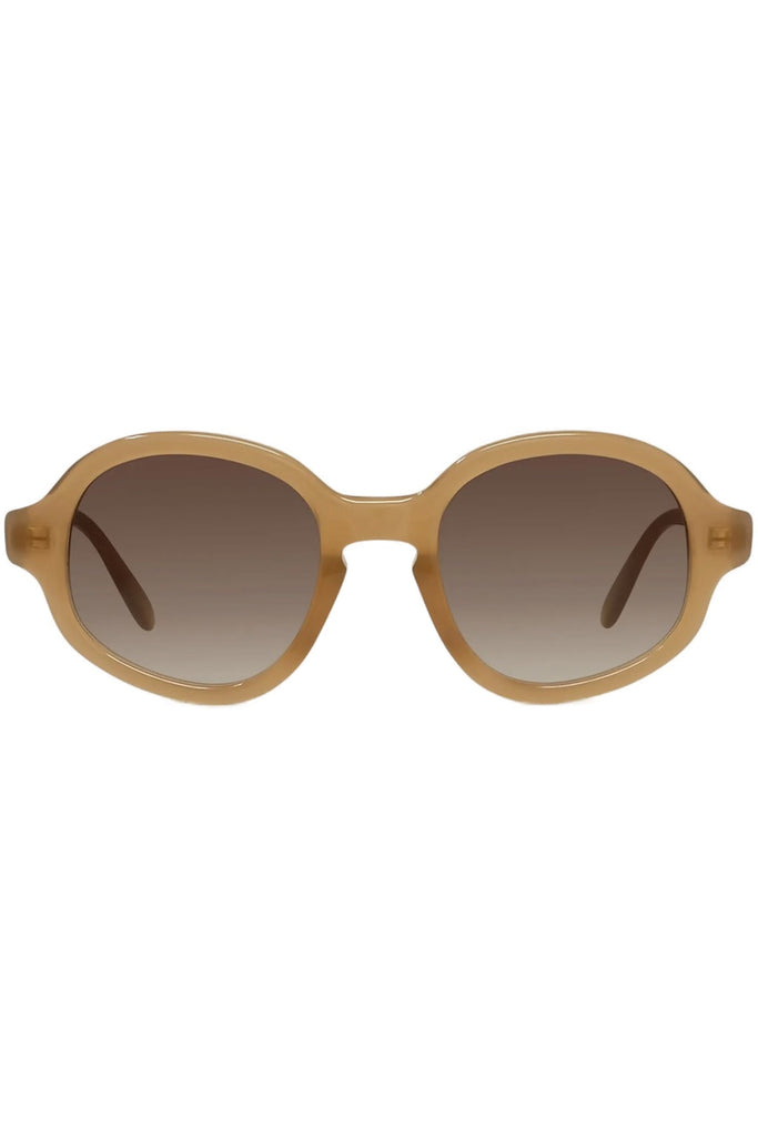 Oval sunglasses with a translucent warm tan frame and brown gradient lenses, shown against a plain white background.