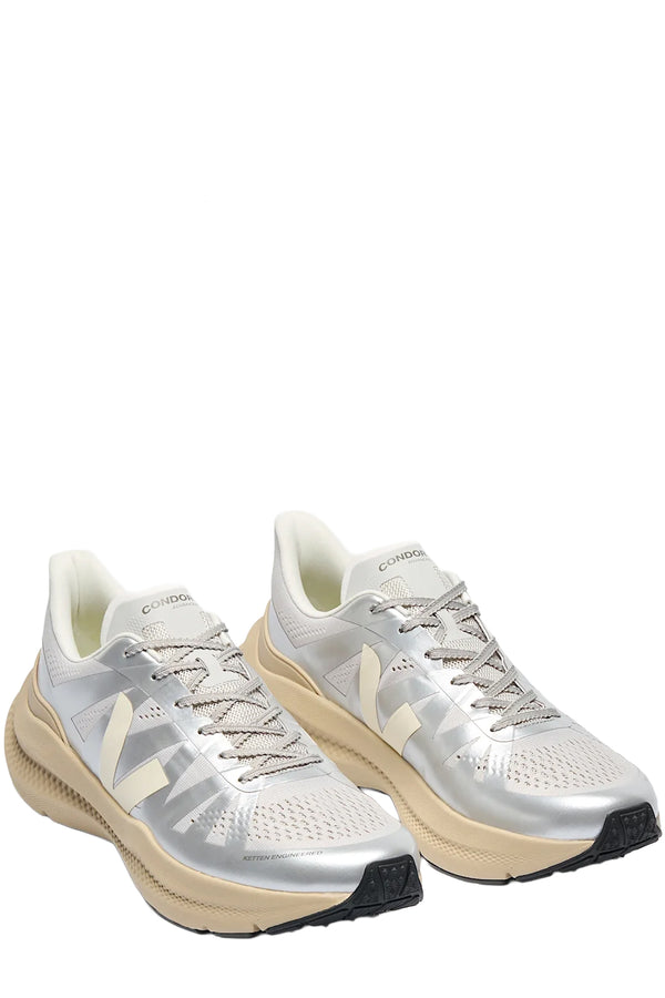 Top view pair of Veja running shoes in metallic silver and white with beige accents, shown against a plain white background.