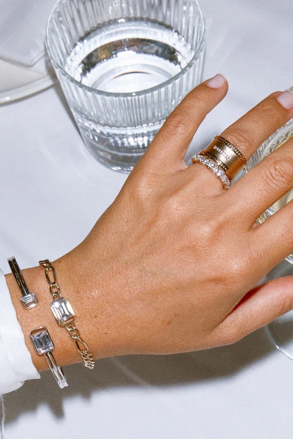 Model wearing the Norma bangle bracelet in silver and clear colours from the brand HEAVENLY LONDON